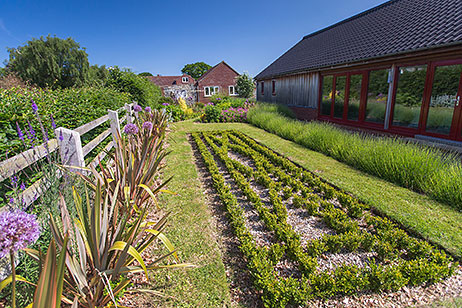 Formal arrangement of box hedging outside the swimming pool building