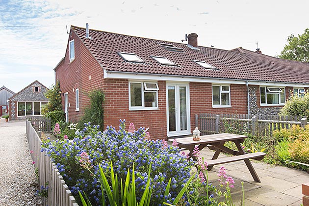 Home Farm End Cottage outside from over its garden