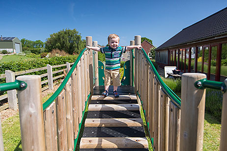Toddler on ramp of climbing frame